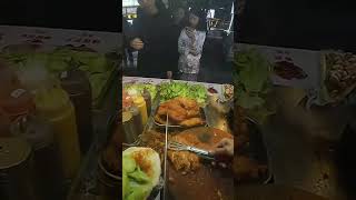 Download the video "Spicy Skewers: A Fiery Delicious Street Treat"