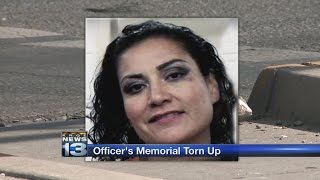 Woman accused of vandalizing slain officer memorial