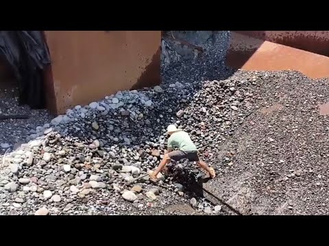 Barge unloading 2800 tons river rock - empty barge  - relaxing video, relaxing smooth rock flow