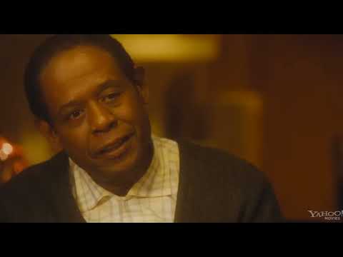 The Butler (2013) trailer frame: Cecil Gaines in White House service doorway watching history unfold