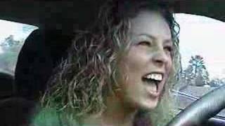 Amber Whitworth singing in her car commercial.
