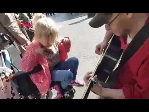 7 year old autistic blind girl in a wheel chair plays guitar for the first time