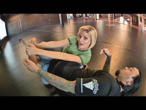 Eddie Bravo shows the Vaporizer leg lock on Joanne of MMA Girls