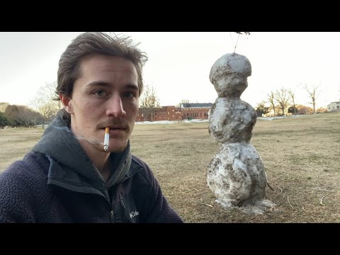 Smoking Alone in a Public Park with Some Snow on the Ground
