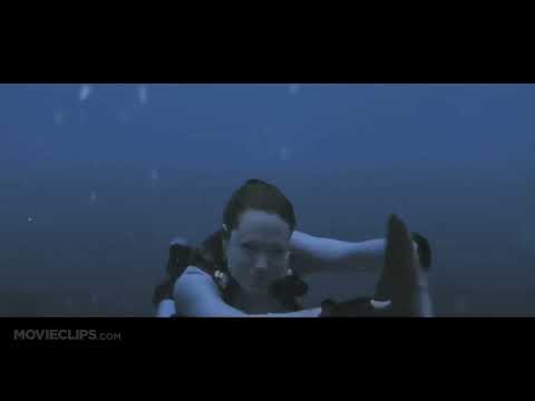 Official trailer still: Angelina Jolie as Lara Croft surfaces from a dive as drums surge and the sequel leans into globe-trotting spectacle