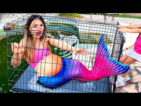 The pregnant mermaid is locked in a cage above the poison pool!
