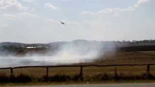 preview picture of video 'Aerial Fire Fighting - Plane bombing grass fire near houses'