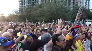 Venezuelans sing national anthem during Miami demonstration
