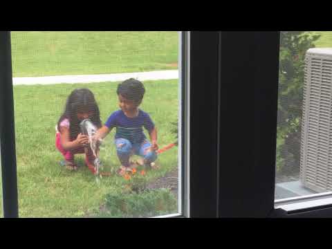 Zara and Zuhair watering their flowers