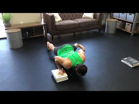 Deficit single arm push ups