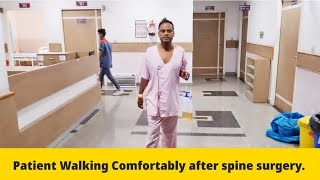 Patient walking after spine surgery.