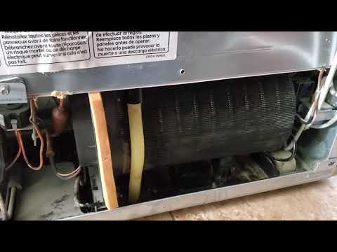 GE Profile refrigerator leaking water, clogged drain tube repair.