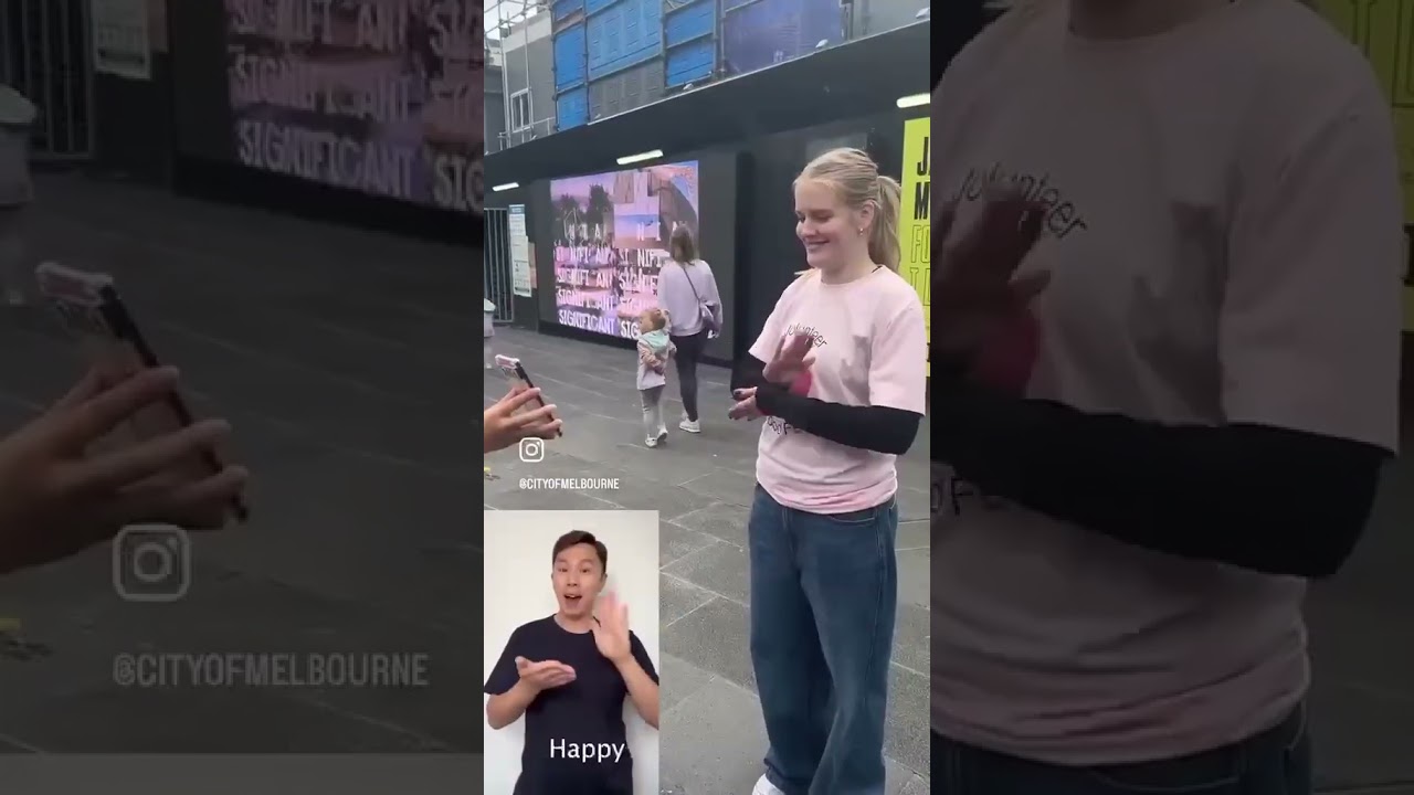 Elvin Lam (Geo) teaches Melbournians how to sign Happy Auslan Day