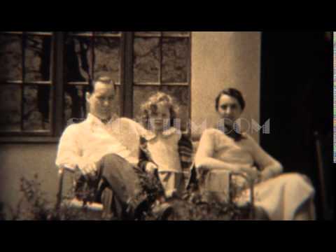 1937: Stern smileless father with curly haired daughter and timid mother. TRYON, NC