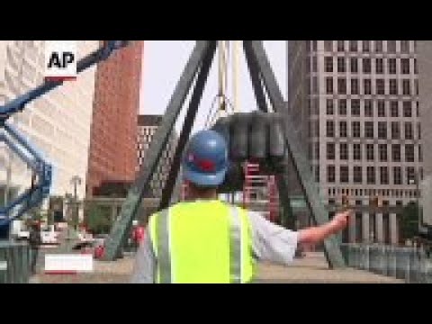 Work began Wednesday on Detroit's massive sculpture of the arm and hand of heavyweight champion Joe