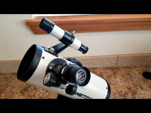 The planet Jupiter and its visible moons viewed through a table top telescope