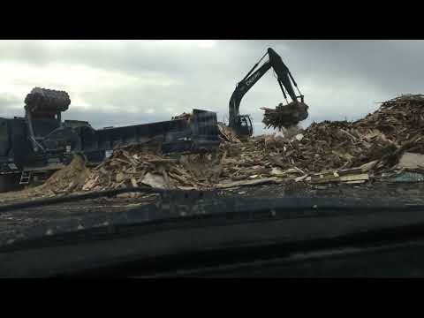 feeding a DuraTech grinder at the dump