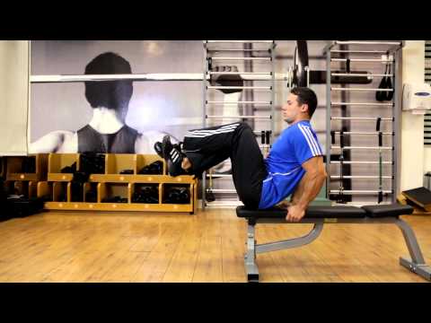 Seated Flat Bench Leg Pull In - Abs Exercise