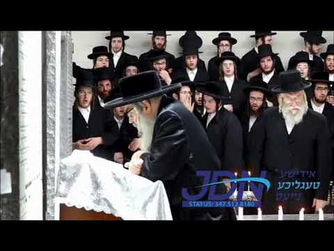 Satmar Rebbe davening at the graves of previous satmar Rebbes