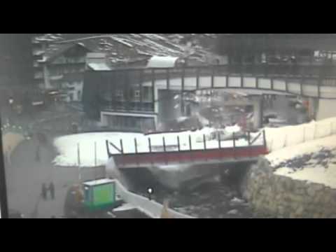 Snow plough falls through bridge