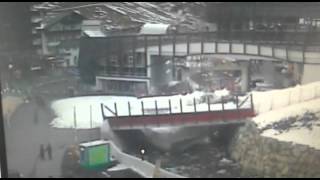 Snow plough falls through bridge