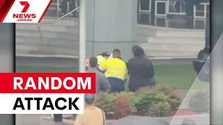 Mother stabbed protecting son outside police headquarters | 7NEWS