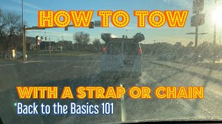 How to tow a vehicle with a strap or chain.