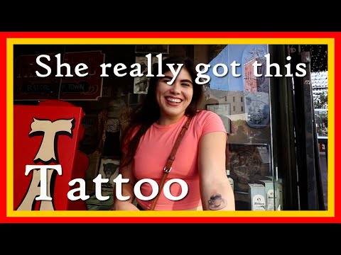 She got a tattoo for her love | A squid fighting a shark | and a black Panther tattoo on a shoulder