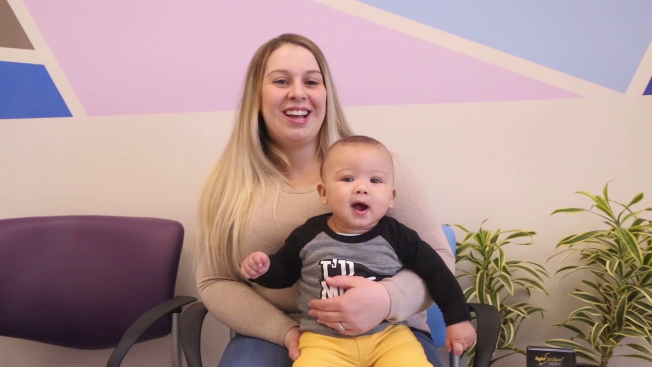 Smiling woman with her baby on her lap