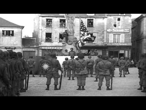 Civilians watch US soldiers as they are awarded in Carentan, France during World ...HD Stock Footage