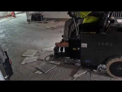 Removing ceramic flooring tiles with ease using the 5700 Ride On floor scraper.