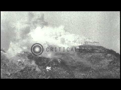 A great number of explosions on a hillside and directly upon Benedictine Monaster...HD Stock Footage