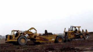 CAT D10N loading 651B’s in the rain