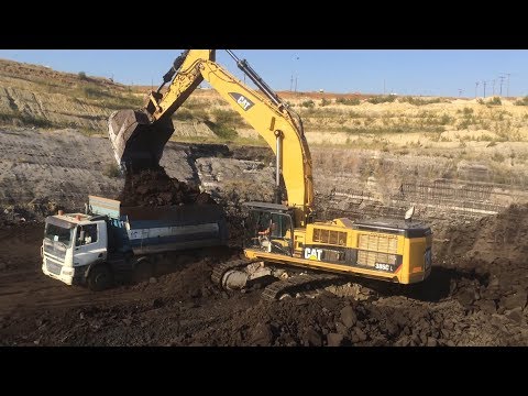 Caterpillar 385CLME Excavator Loading Coal On Trucks