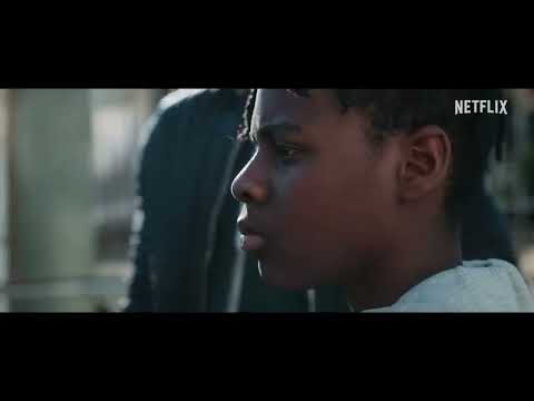 The Kitchen 2024 Netflix trailer frame: Izi and Benji cross a barricaded London estate at dusk