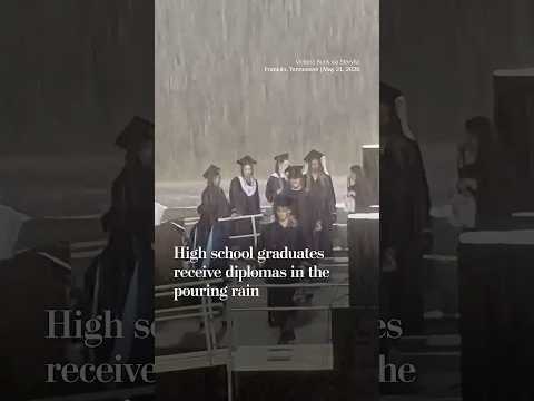 High school graduates receive diplomas in the pouring rain