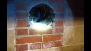 Installing a stove pipe through wall in an existing masonry chimney DIY Do it yourself how to video.