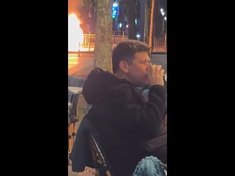 A couple enjoys a drink amid the Paris riots