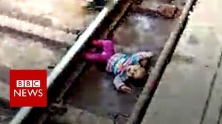 Indian baby&#39;s close call with train - BBC News