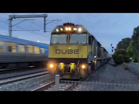 Qube freight train with long horn passes a Comeng at Dallas