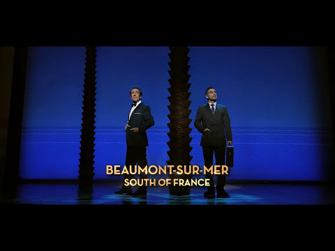 Trailer still with leading men and ingénue staged front-of-curtain like a curtain-call pose