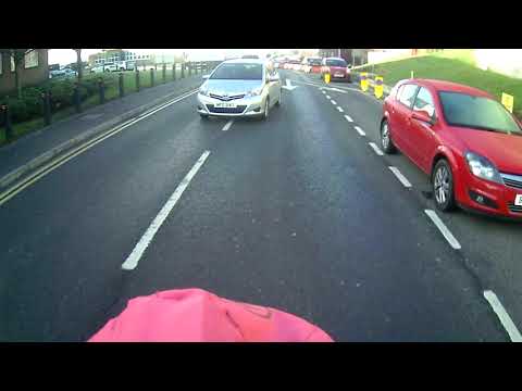 Cyclist gives way at a hospital crossing whilst driver overtakes.