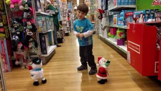 Hilarious kid dancing in the aisles of Toys R Us to I'm too Sexy Snowman & Santa Selfie songs
