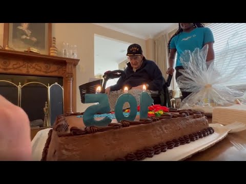 Senior woman in wheelchair enjoying time in the park with caregiver