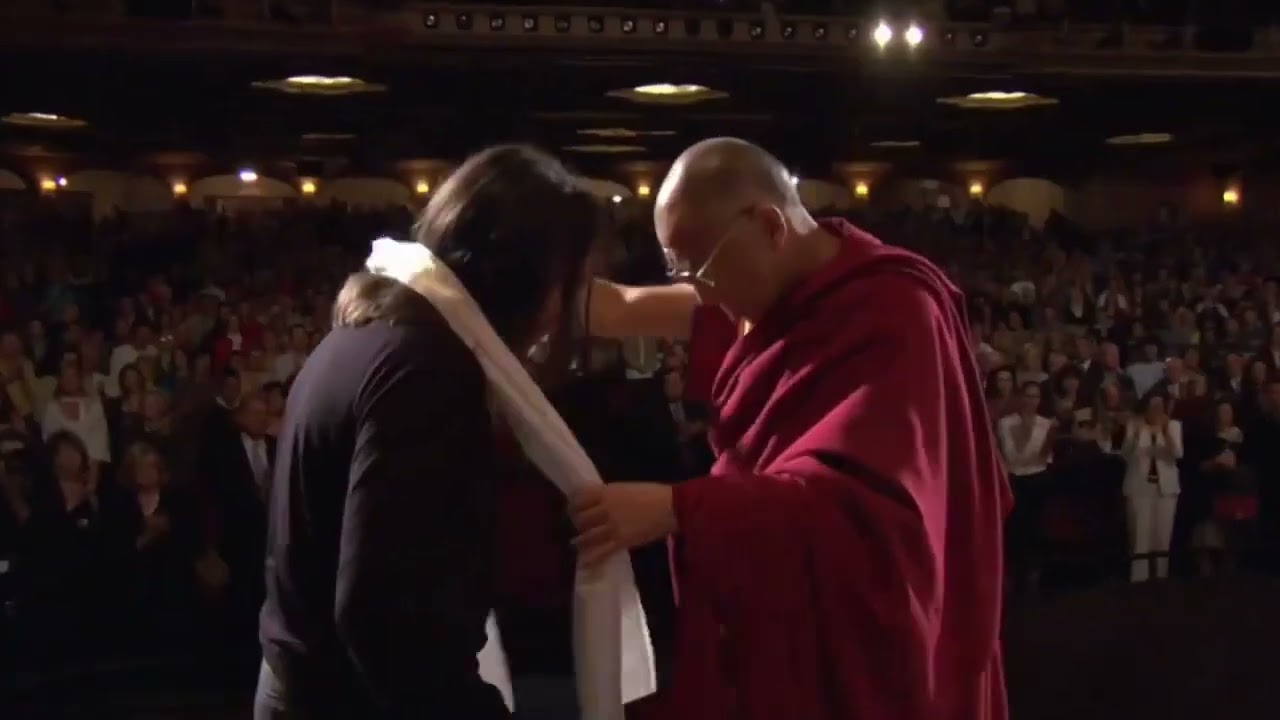 Keith Raniere receives a Khata scarf from the Dalai Lama