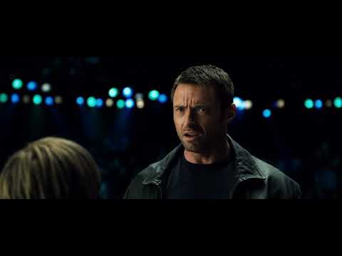 Real Steel (2011) trailer frame — Atom takes center ring under floodlights as the crowd roars and rock beats surge