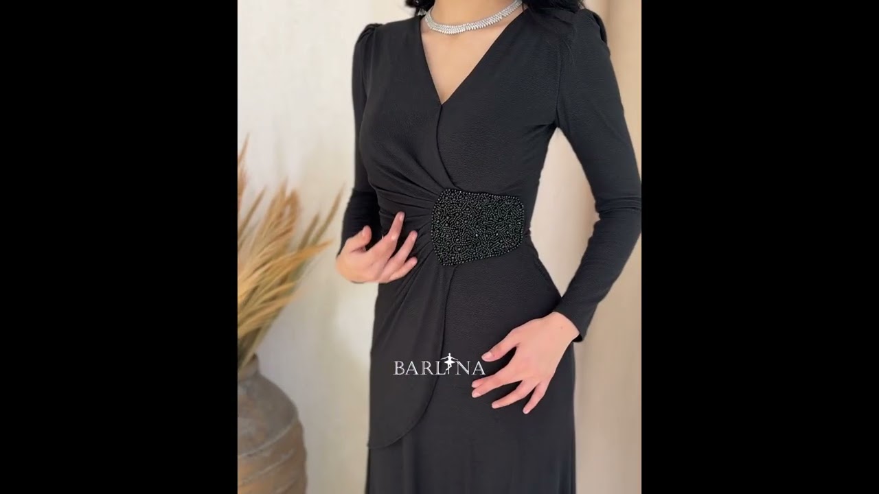 A black wrap dress with an elegant brooch - L