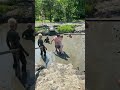 Man Helps A Disabled Woman Into A Mud Bath