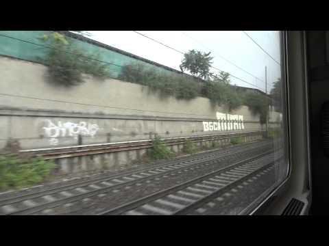 A train leaving from the Milan central railwaystation towards Chiasso, Swizerland border