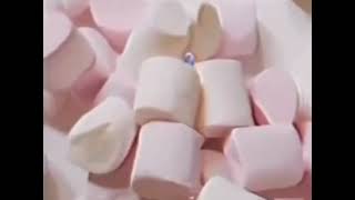 Blue creature screaming in marshmallow pile